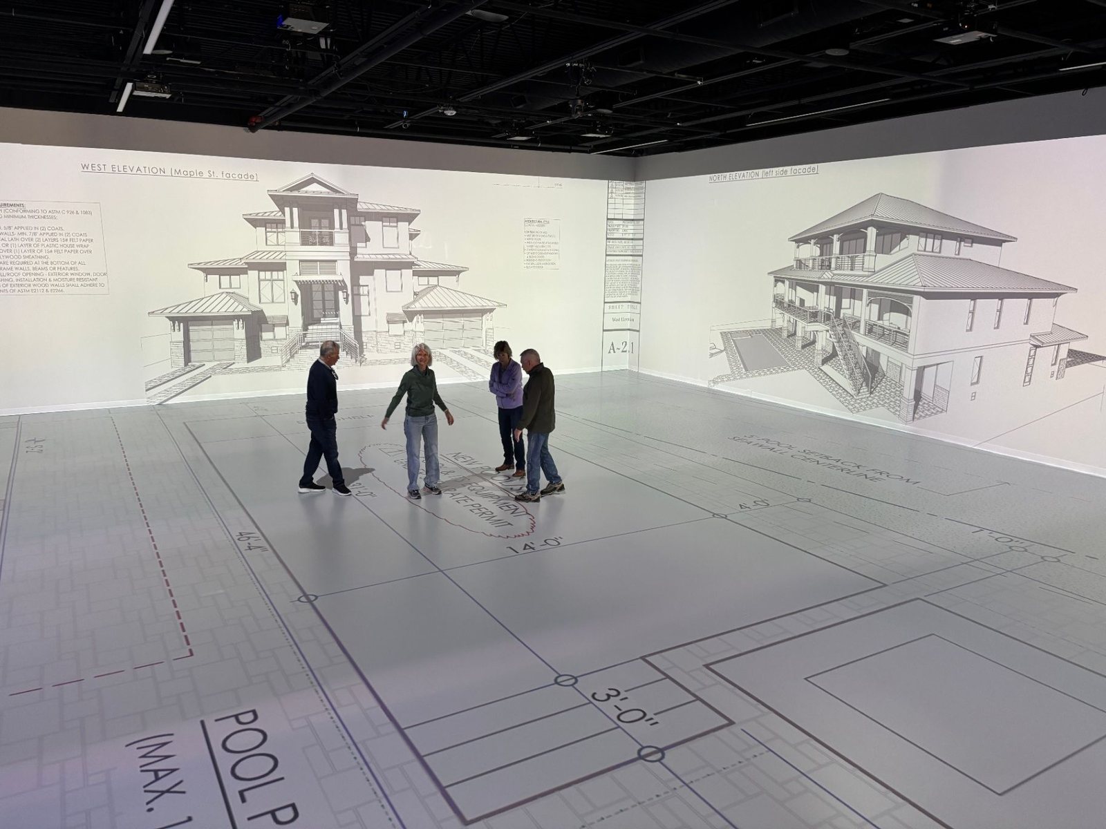 Full-scale plans projected across the studio