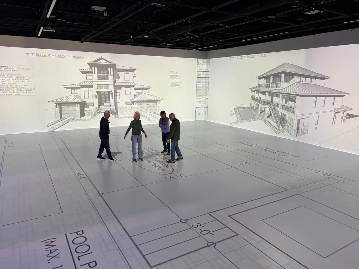 Full-scale plans projected across the studio