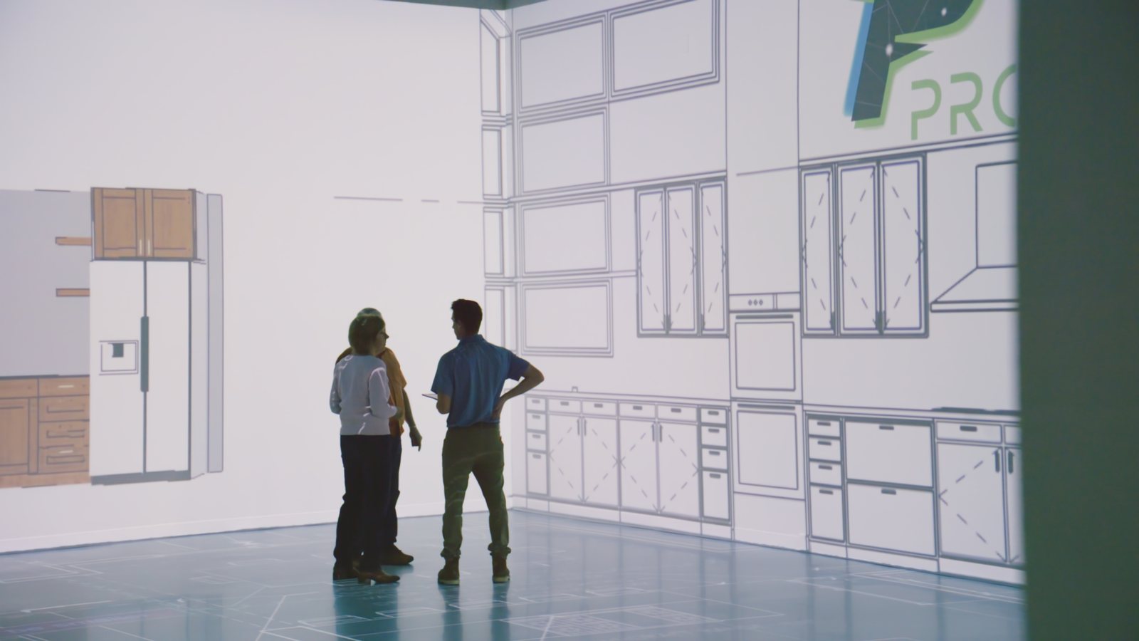 Wraparound wireframe projection across two studio walls with people standing inside it